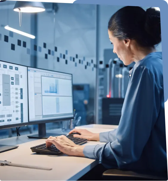 Woman working on computer with data charts.